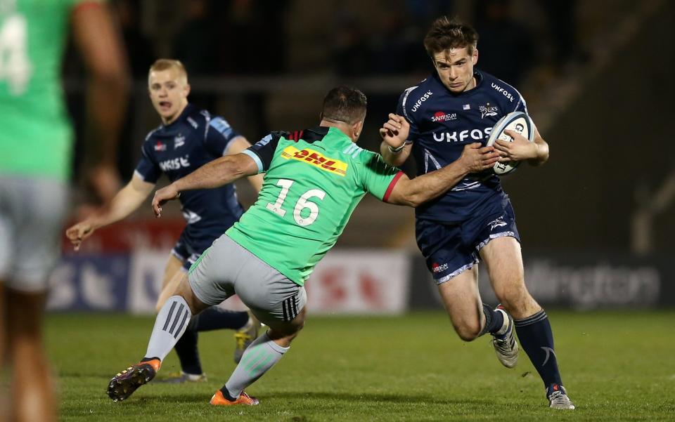 AJ MacGinty of Sale Sharks breaks through the tackle of Dave Ward - GETTY IMAGES