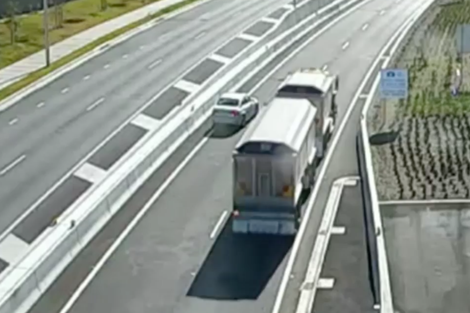 Pictured is a truck hurtling passed a reversing car at the entrance of the WestConnex tunnel.