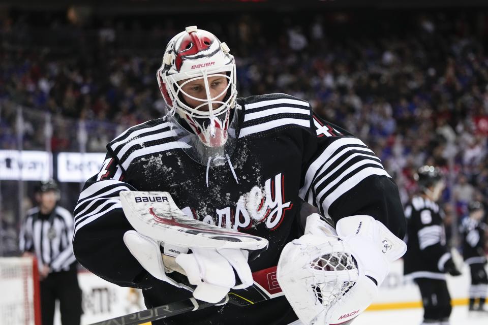 New Jersey Devils goaltender Vitek Vanecek (41) reacts after New York Rangers' Adam Fox (23) collided with him during the first period of an NHL hockey game Thursday, March 30, 2023, in Newark, N.J. (AP Photo/Frank Franklin II)