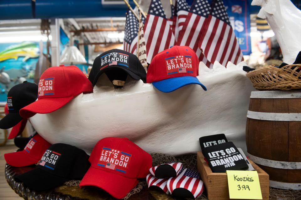 "Let's Go Brandon"" hats are displayed at a store at a flea market site in Stuart.