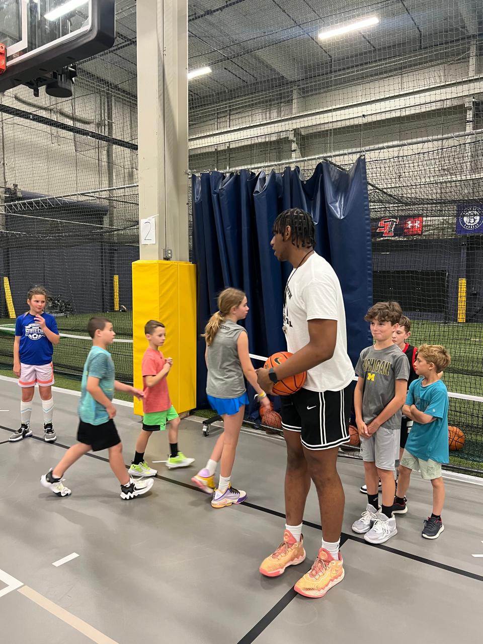 Michigan basketball player Tarris Reed Jr. works with campers at the "Ballin' on Break" basketball camp at Action Sports and Community Center in South Lyon on Wednesday, June 21, 2023.