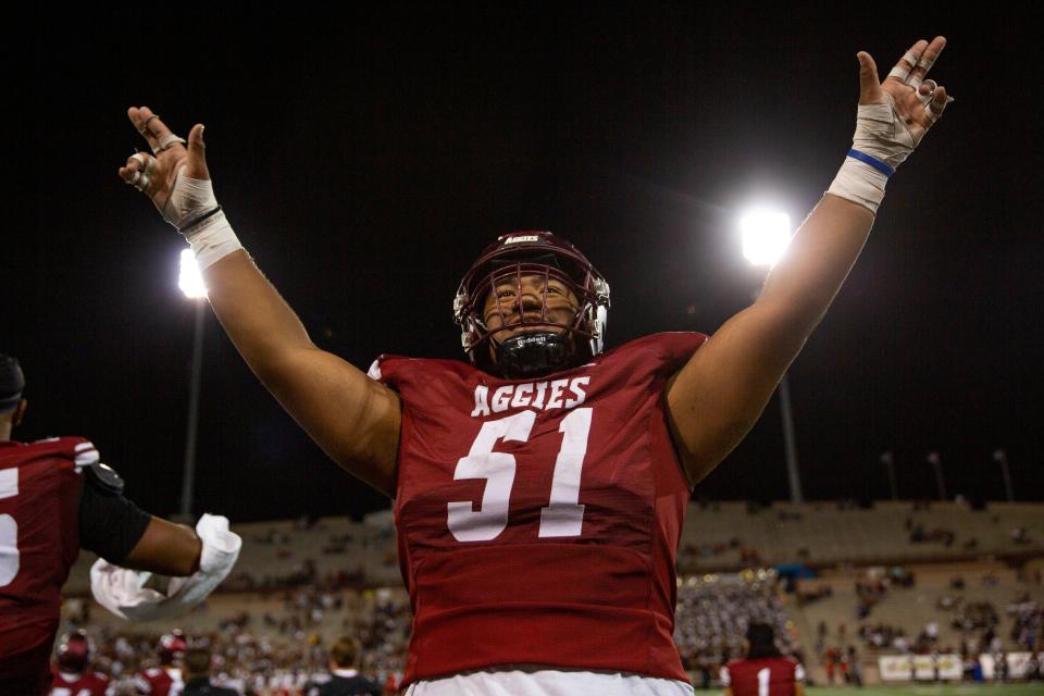 NMSU football players celebrate their win against UNM on Saturday, Oct. 15, 2022, at Aggies Memorial Stadium. They defeated their rival 21-9. 