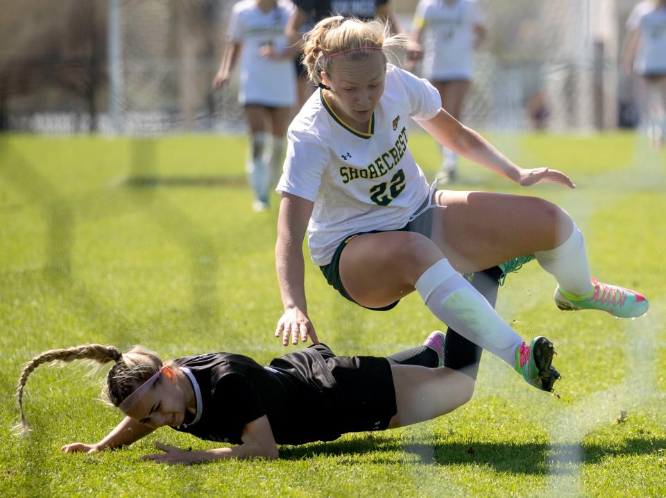 Lakeland Christian's Ella Williams (11) is knocked to the ground against Shorecrest Prep in the finals of the 2024 FHSAA Class 2A Girls Soccer Finals at the Lake Myrtle Soccer Complex in Auburndale.