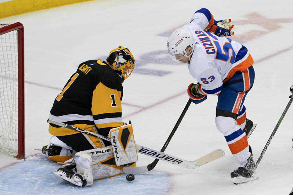 Pittsburgh Penguins goaltender Casey DeSmith (1) stops a shot by New York Islanders' Casey Cizikas (53) during the third period of an NHL hockey game, Monday, March 29, 2021, in Pittsburgh. (AP Photo/Keith Srakocic)