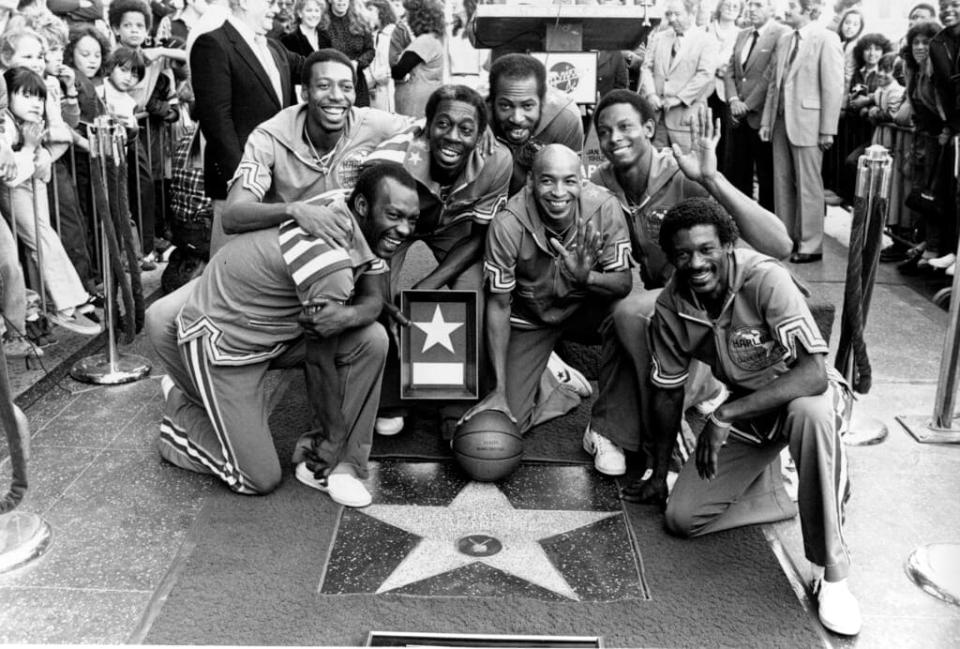 The Harlem Globetrotters are honored with a star on the Hollywood Walk of Fame in California on Tuesday, Jan. 19, 1982. The Globetrotters became the first athletic team to be honored with a star on the sidewalk. Posing from left to right are, Billy Hobley, Dallas Thornton, Hubert “Geese” Ausbie, Nate Branch, Fred “Curly” Neal, Robert Paige and Gator Rivers. (AP Photo/Lennox McLendon)