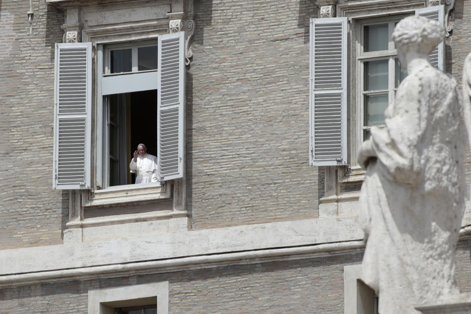 Pope Francis gives his blessing from his studio's window, overlooking St. Peter square, at the Vatican Sunday, May 17, 2020. During his weekly Sunday blessing, Pope Francis welcomed the fact that from Monday Holy Mass can be celebrated in Italy with the congregation present -- but he urged the faithful to follow the rules. ‘’Please, let’s go ahead with the norms, the prescriptions, that they give us to safeguard the health of each of us, and of the people.’’ (AP Photo/Alessandra Tarantino)