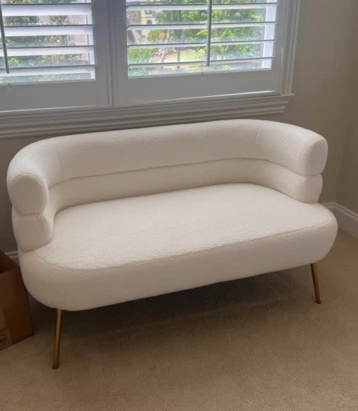 the loveseat with a curved silhouette