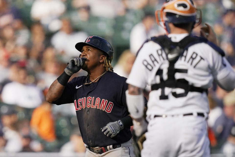 Cleveland Guardians' Jose Ramirez looks skyward as he passes Detroit Tigers catcher Tucker Barnhart after a two-run home run during the ninth inning of a baseball game, Saturday, May 28, 2022, in Detroit. (AP Photo/Carlos Osorio)