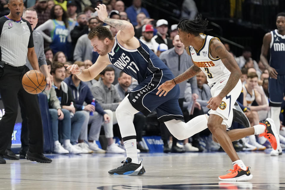 Dallas Mavericks guard Luka Doncic (77) loses control of the ball against Denver Nuggets guard Bones Hyland (3) during the second half of an NBA basketball game in Dallas, Sunday, Nov. 20, 2022. (AP Photo/LM Otero)