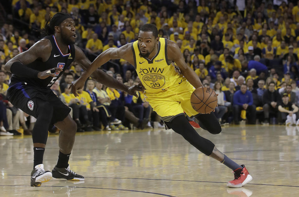 Golden State Warriors forward Kevin Durant (35) drives against Los Angeles Clippers forward Montrezl Harrell (5) during the second half of Game 2 of a first-round NBA basketball playoff series in Oakland, Calif., Monday, April 15, 2019. (AP Photo/Jeff Chiu)