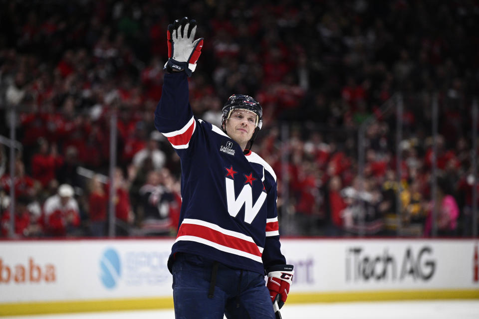 Washington Capitals defenseman John Carlson (74) waves to the crowd as he is recognized for playing in his 1,000th NHL hockey game during the first period against the Boston Bruins, Saturday, March 30 2024, in Washington. This is Carlson's 1,000th NHL game. (AP Photo/Nick Wass)