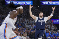 Dallas Mavericks guard Luka Doncic, right, reacts as Oklahoma City Thunder guard Luguentz Dort looks on during the first half of Game 1 of an NBA basketball second-round playoff series, Tuesday, May 7, 2024, in Oklahoma City. (AP Photo/Nate Billings)