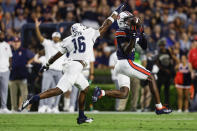 Auburn wide receiver Omari Kelly, right, catches a pass over Samford cornerback Kamron Smith (16) for a first down during the first half of an NCAA college football game Saturday, Sept. 16, 2023, in Auburn, Ala. (AP Photo/Butch Dill)