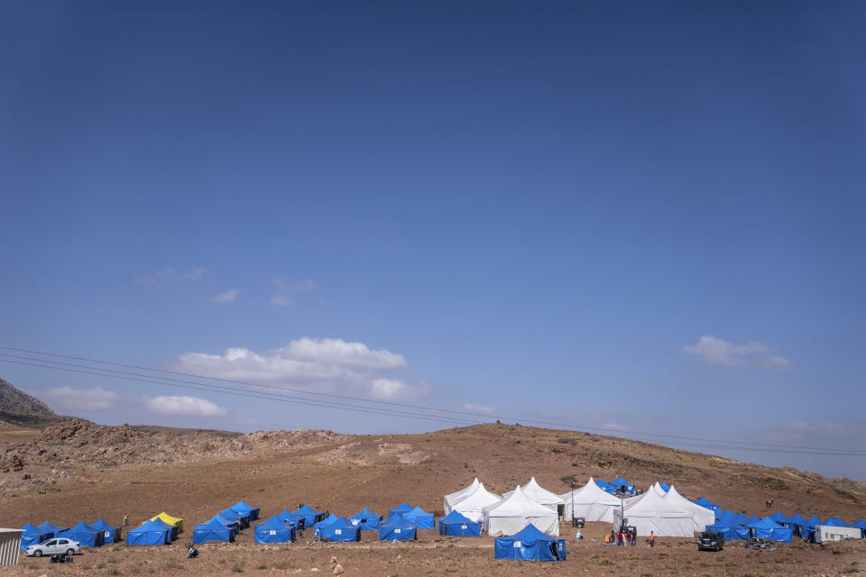 Tents housing people who were displaced by the earthquake in the town of Douzrou, outside Marrakech, Morocco, Wednesday, Sept. 13, 2023. An aftershock rattled central Morocco on Wednesday, striking fear into rescue crews at work in High Atlas villages, digging people out from rubble that could slide. (AP Photo/Mosa'ab Elshamy)