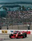 FILE - Italian driver Alex Zanardi rounds the eighth turn of the Toyota Grand Prix of Long Beach in Long Beach, Calif., in this Sunday, April 13, 1997, file photo. A Wyland whale mural is on the wall of a building behind the grandstands. (AP Photo/Kevork Djansezian)