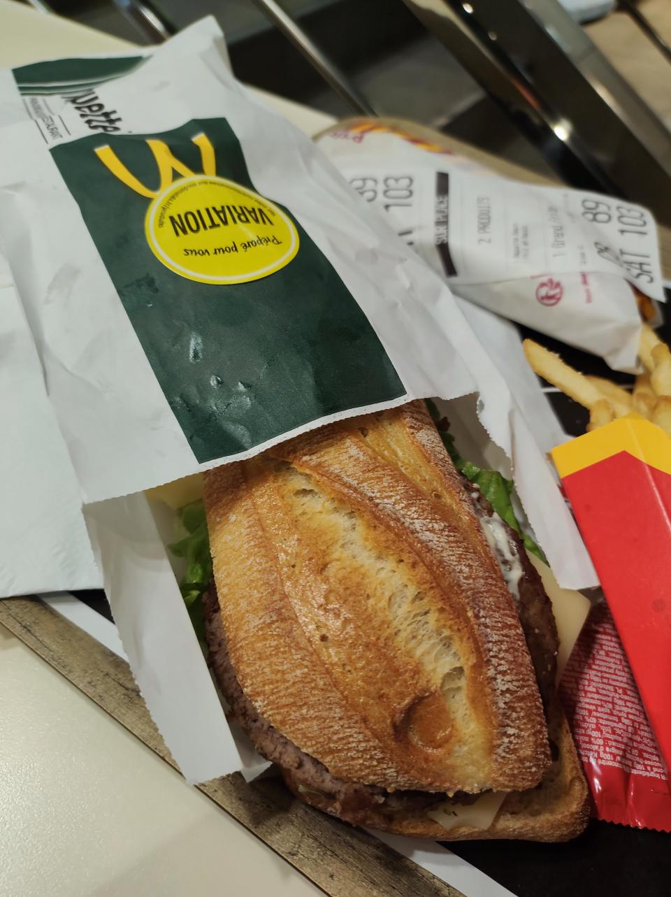 A baguette emerging from McDonald's packaging