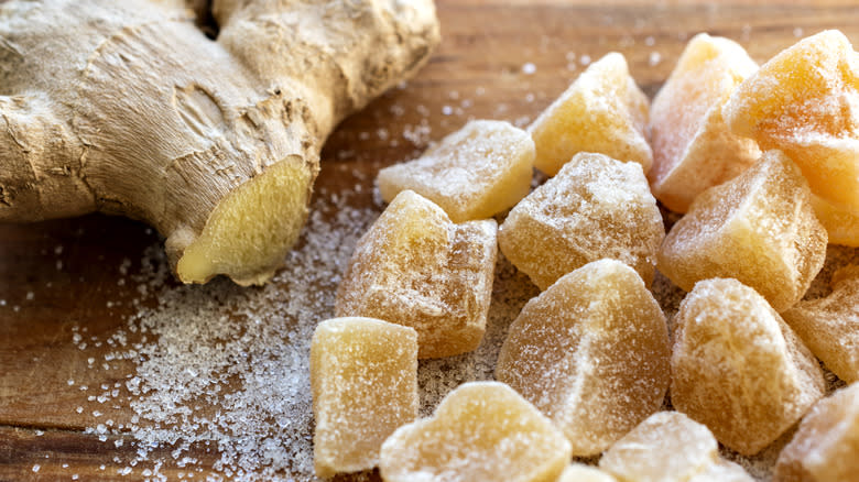 Ginger root next to pieces of candied ginger