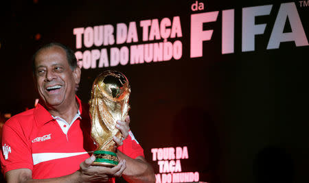 Brazilian former soccer player Carlos Alberto Torres holds the trophy during the FIFA World Cup "Trophy Tour" at Maracana stadium in Rio de Janeiro April 22, 2014. REUTERS/Ricardo Moraes/File Photo