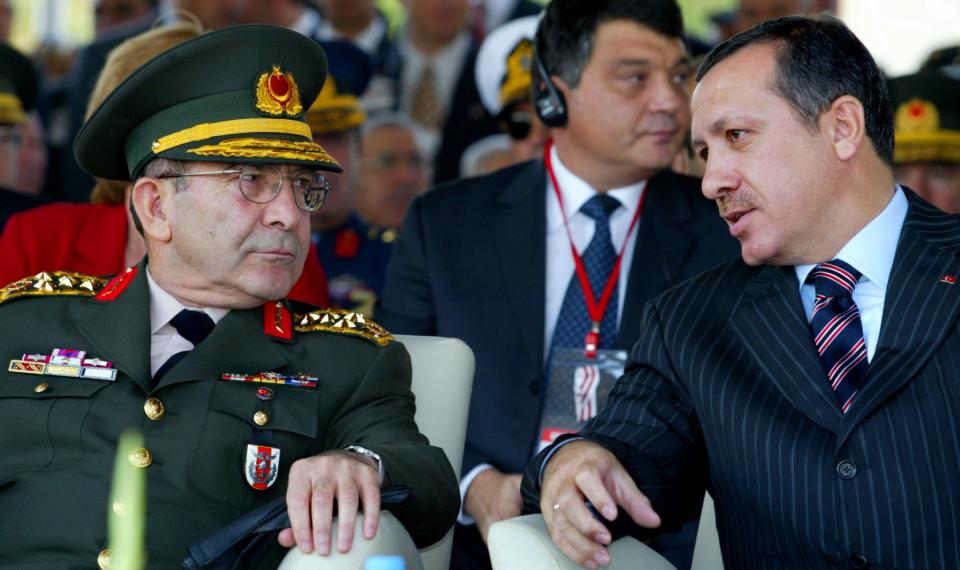 <p>Turkish Prime Minister Tayyip Erdogan (R) chats with Chief Of Staff<br> General Hilmi Ozkok (L) during the opening ceremony of the Sixth<br> International Defence Industry, Aerospace and Maritime Fair (IDEF) in<br> Ankara, September 30, 2003. (Stringer/Reuters) </p>