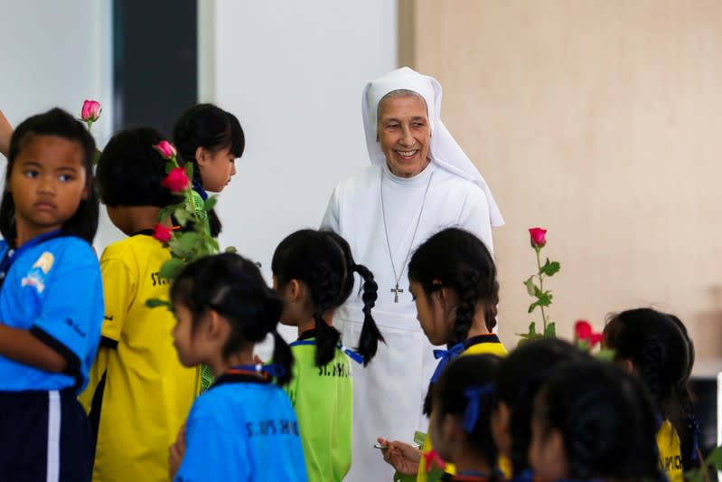 Sister Ana Rosa Sivori smiles as she walks with students at the St. Mary School in Udon Thani province