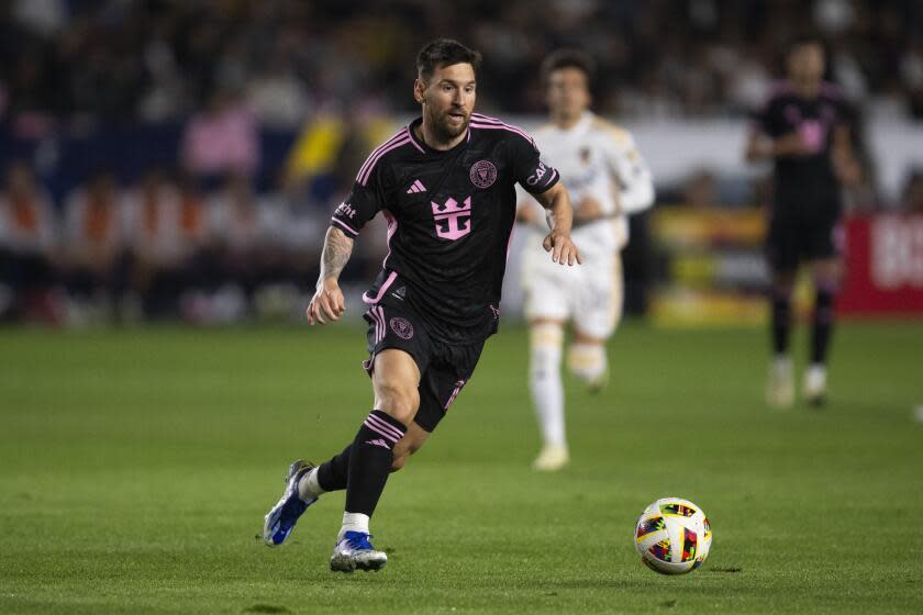 Inter Miami forward Lionel Messi (10) dribbles the ball during the first half of an MLS soccer match against the Los Angeles Galaxy, Saturday, Feb. 25, 2024, in Carson, Calif. (AP Photo/Kyusung Gong)