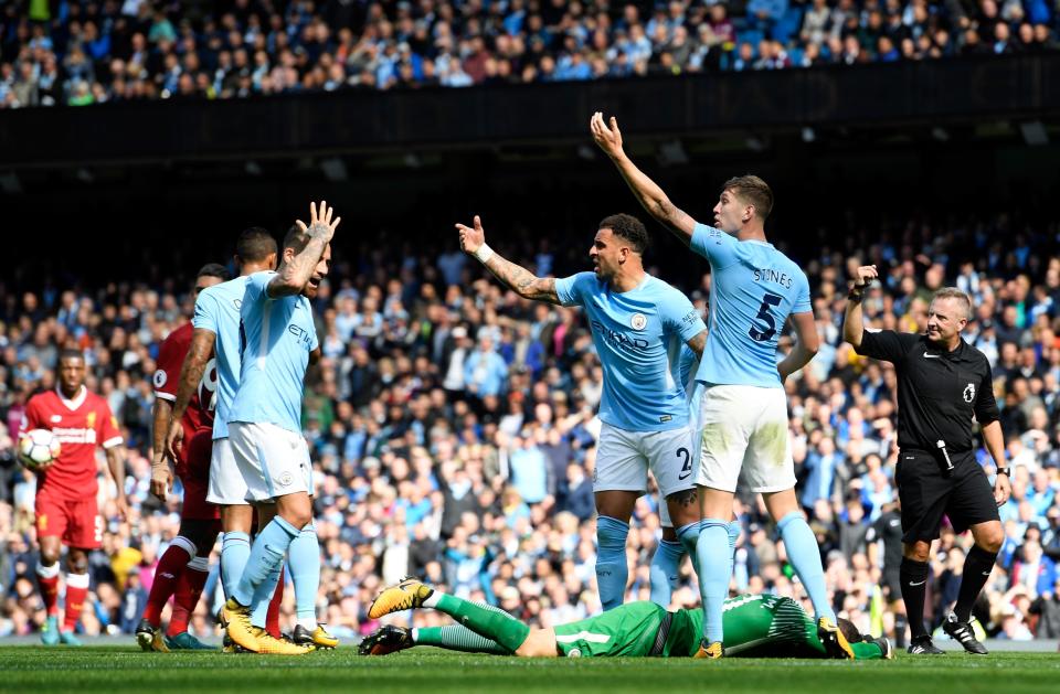 <p>Kyle Walker of Manchester City and John Stones of Manchester City gesture for the Manchester City medical team as Ederson of Manchester City goes down injured after a challenge from Sadio Mane </p>