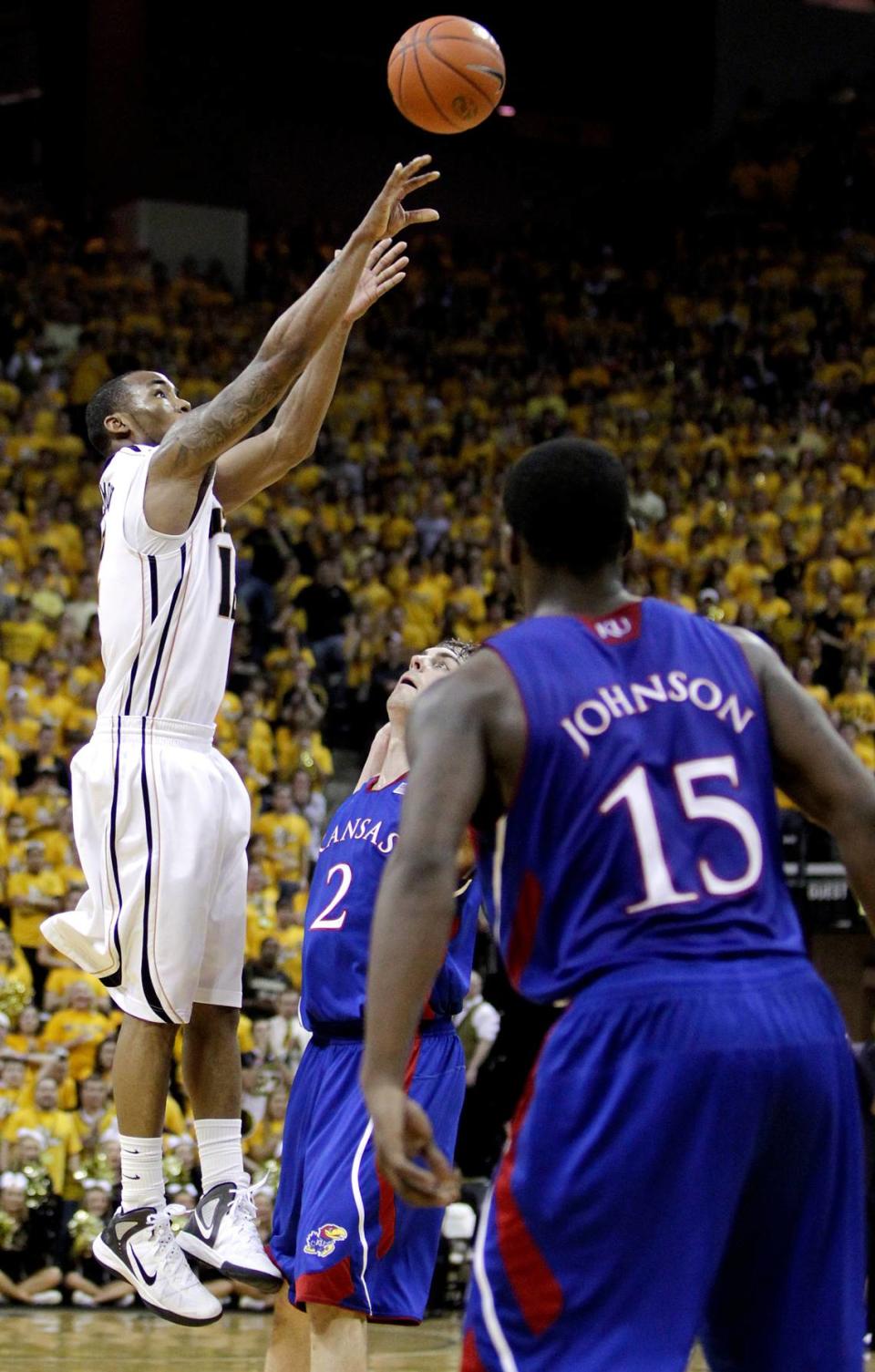 MU’s Marcus Denmon hit this three-pointer over KU’s Conner Teahan from the right wing late in the Tigers’ 74-71 win on Feb. 4, 2012 at Mizzou Arena in Columbia.