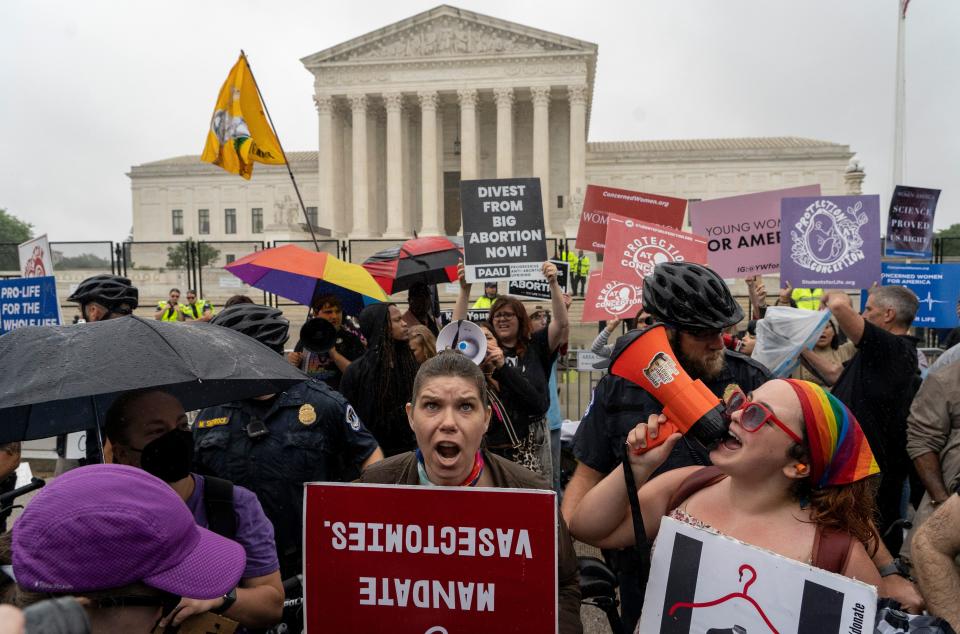 Abortion-rights protesters and anti-abortion protesters, divided by a police line, demonstrate in front of the Supreme Court in Washington, Thursday, June 23, 2022.