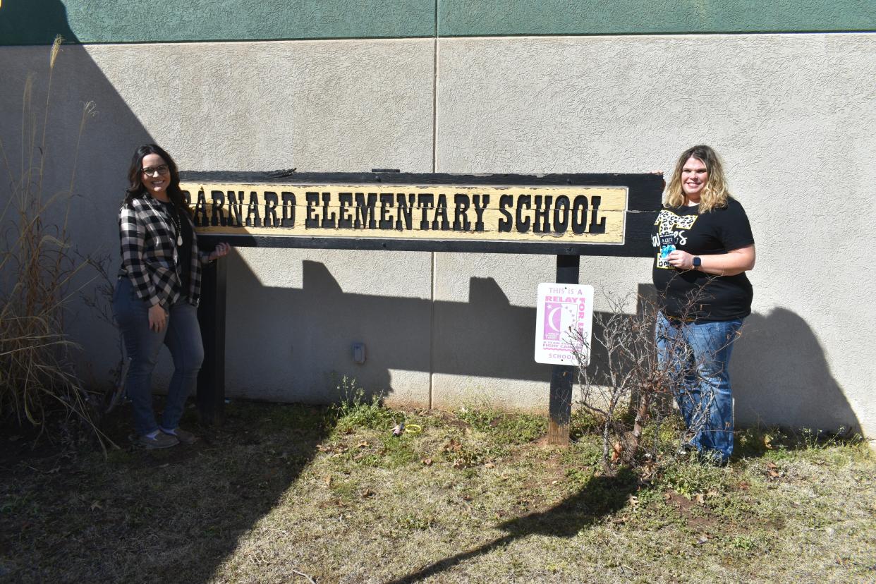 Holly Donaghey and Barnard Elementary School Principal Jana Phelps, left, stand outside the school after Donaghey received her $100 Visa gift card and the title of February Teacher of the Month.