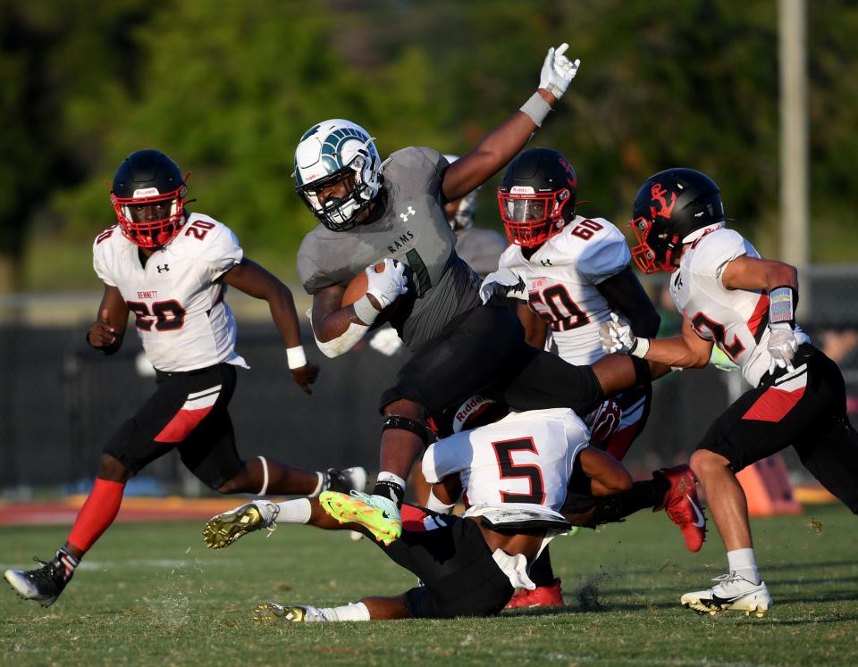 Parkside's Bryant Waters (1) jumps over Bennett's Dashon Matthews (5) Friday, Sept. 9, 2022, at the Wicomico County Stadium in Salisbury, Maryland.