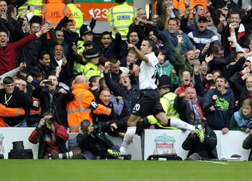 Manchester United's Robin Van Persie celebrates after he scored the second goal of the game for his side during an English Premier League soccer match against Liverpool at Anfield in Liverpool, England, Sunday Sept. 23, 2012. (AP Photo/Clint Hughes)