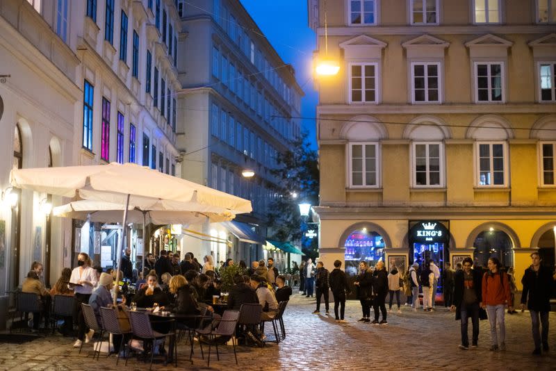 People enjoy an evening drink after Austria eases its COVID-19 restrictions