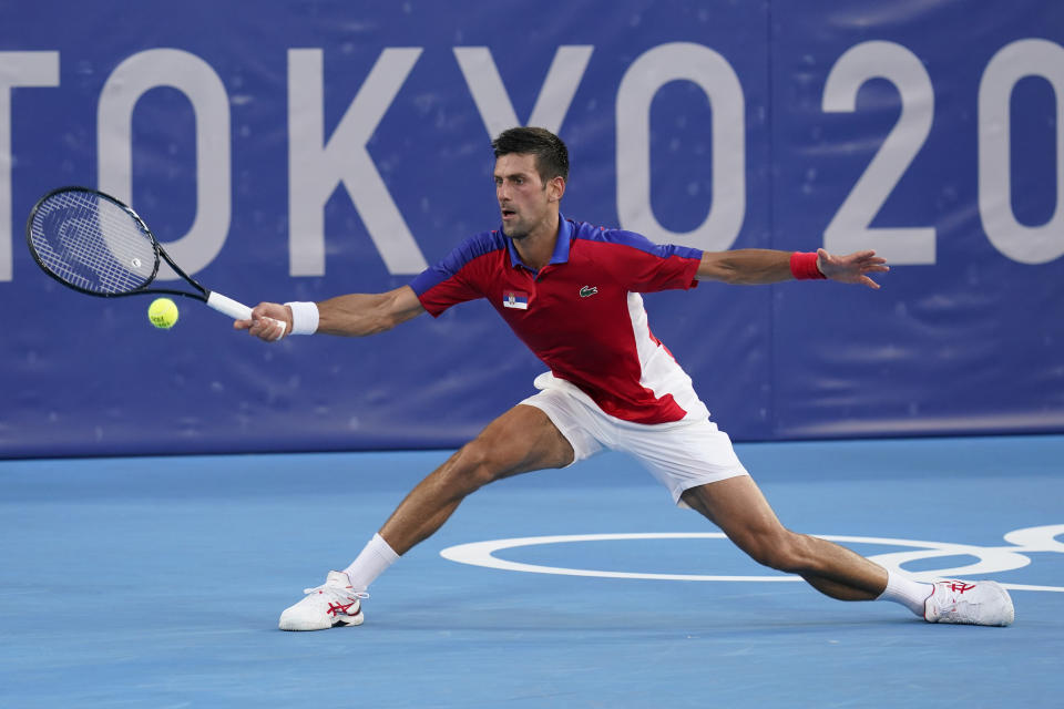 Novak Djokovic, of Serbia, returns to Alejandro Davidovich Fokina, of Spain, during the third round of the men's tennis competition at the 2020 Summer Olympics, Wednesday, July 28, 2021, in Tokyo, Japan. (AP Photo/Patrick Semansky)