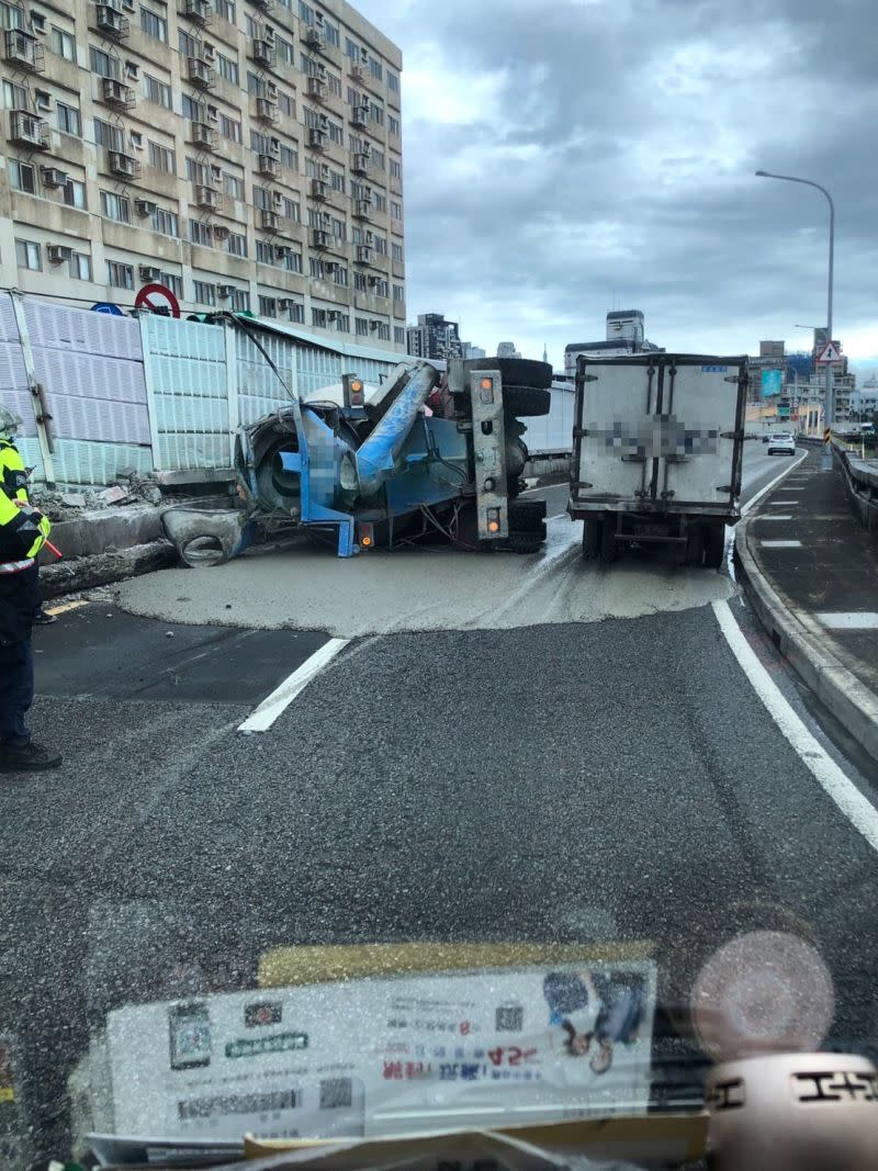 台北市中正區水源快速道路往新店方向，一輛預拌混凝土車因不明原因翻覆，撞擊力道猛烈，連一旁的隔音牆也被撞倒。（圖／翻攝畫面）