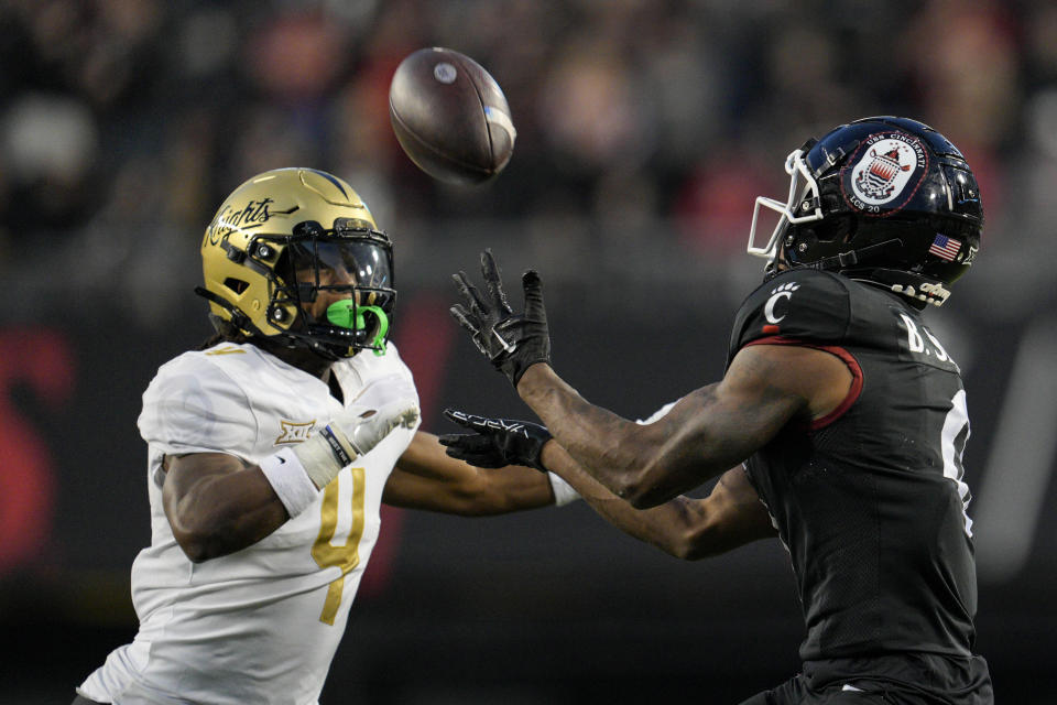 Cincinnati wide receiver Braden Smith, right, makes a catch against Central Florida defensive back Braeden Marshall (4) during the second half of an NCAA college football game, Saturday, Nov. 4, 2023, in Cincinnati. (AP Photo/Jeff Dean)