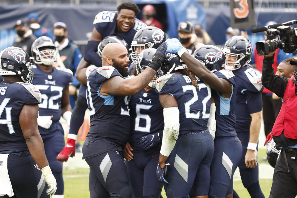 Tennessee Titans running back Derrick Henry (22) is mobbed by teammates after Henry scored the winning touchdown against the Houston Texans in overtime of an NFL football game Sunday, Oct. 18, 2020, in Nashville, Tenn. The Titans won 42-36. (AP Photo/Wade Payne)