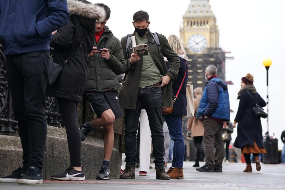 People queuing on Westminster Bridge for booster jabs at St Thomas’ Hospital, London (PA)