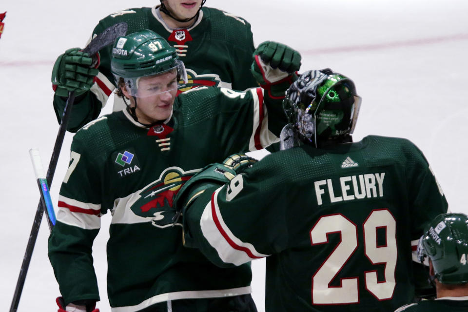 Minnesota Wild left wing Kirill Kaprizov (97) and goaltender Marc-Andre Fleury (29) celebrate the team's overtime win against the Vancouver Canucks in an NHL hockey game Thursday, Oct. 20, 2022, in St. Paul, Minn. (AP Photo/Andy Clayton-King)