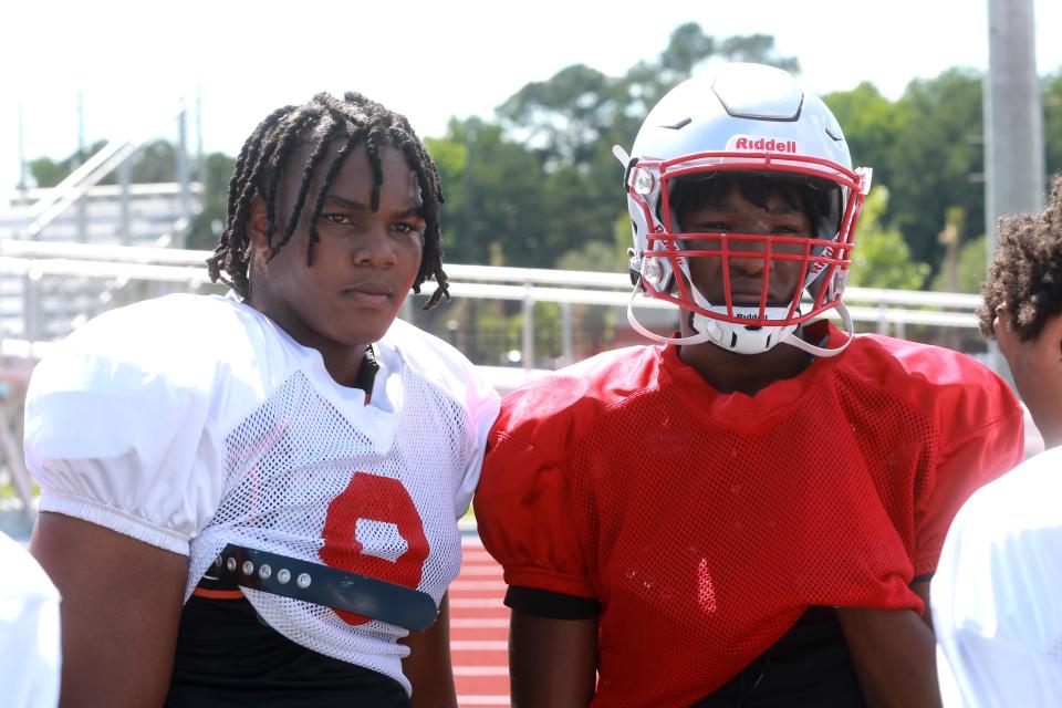 Tavion Gadson stands on the sideline with Lorenzo Cowan during spring practice at Jenkins High.