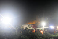 The Air India Express flight that skidded off a runway while landing at the airport in Kozhikode, Kerala state, India, Friday, Aug. 7, 2020. The special evacuation flight bringing people home to India who had been trapped abroad because of the coronavirus skidded off the runway and split in two while landing in heavy rain killing more than a dozen people and injuring dozens more. (AP Photo/C.K.Thanseer)