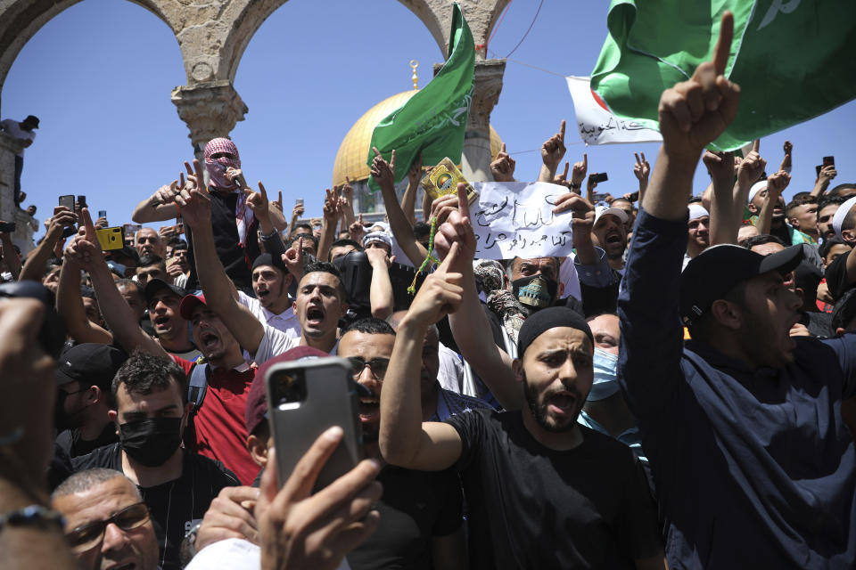 FILE - In this May 7, 2021 file photo, worshippers chant slogans and wave Hamas flags during a protest against the likely evictions of Palestinian families from their homes, at the Dome of the Rock Mosque in the Al Aqsa Mosque compound in the Old City of Jerusalem. The U.S. and the international community are planning to engage with the Palestinians to revive peace efforts, after weeks of unrest and a devastating 11-day war in Gaza. But when U.S. Secretary of State Antony Blinken visits this week, he will meet with unelected leaders who were sidelined by the protests and outmaneuvered by Gaza's militant Hamas rulers. (AP Photo/Mahmoud Illean, File)