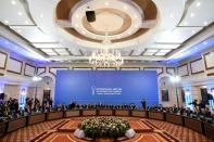 Representatives of the Syria regime and rebel groups along with other attendees take part in the first session of Syria peace talks at Astana's Rixos President Hotel on January 23, 2017