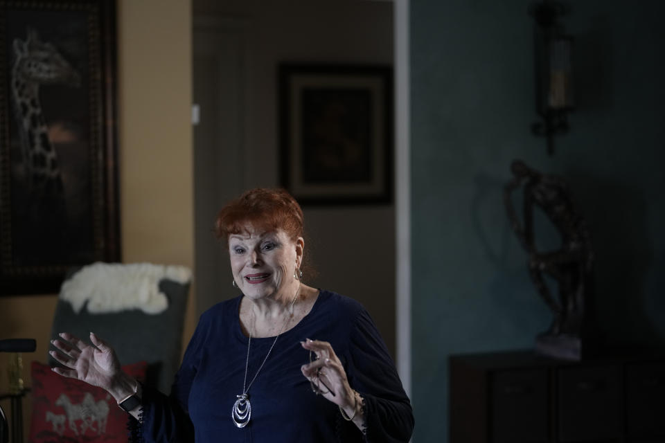 Deanna Dezern, 83, speaks with journalists in her home in Tamarac, Fla., Thursday, Dec. 7, 2023. Dezern is among the first in the country to receive the robot ElliQ, whose creators, Intuition Robotics, and senior assistance officials say is the only device using artificial intelligence specifically designed to lessen the loneliness and isolation experienced by many older Americans. (AP Photo/Rebecca Blackwell)