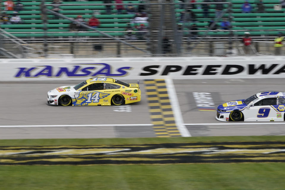 Clint Bowyer (14) leads a pace lap in honor of his final season before a NASCAR Cup Series auto race at Kansas Speedway in Kansas City, Kan., Sunday, Oct. 18, 2020. (AP Photo/Orlin Wagner)