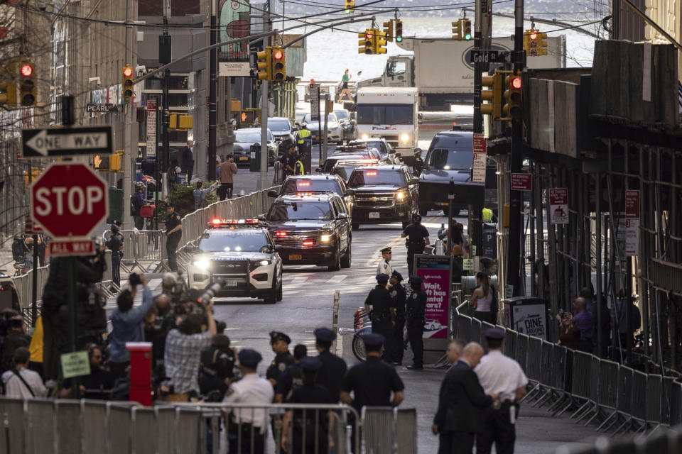 The motorcade of former President Donald Trump arrives at an Attorney General's office building for depositions in a civil investigation in New York, Thursday, April. 13, 2023. Trump is scheduled to meet with lawyers for Attorney General Letitia James, who sued Trump last year. Her lawsuit claims Trump and his family misled banks and business associates by giving them false information about his net worth and the value of assets such as hotels and golf courses.(AP Photo/Yuki Iwamura)