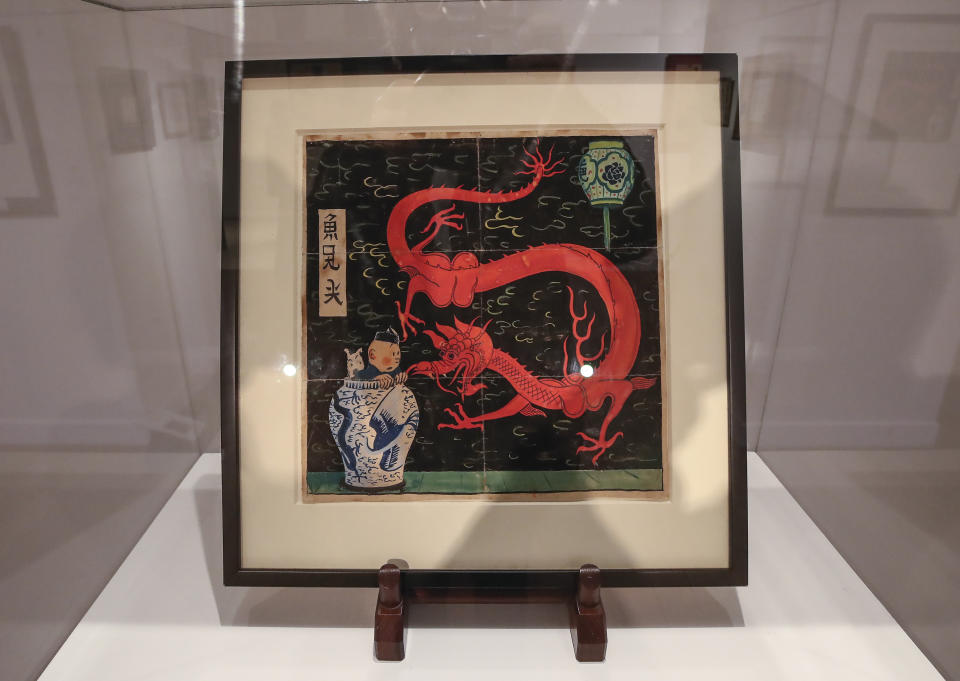 The inked and water-painted original panel of the comic character Tintin from the 1936 "The Blue Lotus" album drawn by Belgian creator Herge, is displayed at the Artcurial auction house in Paris, Wednesday, Jan. 13, 2021. The art work is estimated to fetch The art work with an estimates value of 2.2 to 2.8 million euros (US $ 2.6 to 3.4 million), is going on sale Thursday. (AP Photo/Michel Euler)