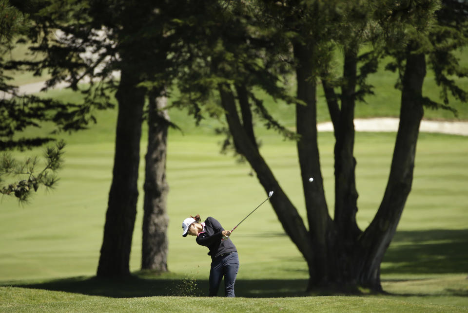 Lydia Ko, of New Zealand, hits an approach shot to the fifth green of Lake Merced Golf Club during the final round of the Swinging Skirts LPGA Classic golf tournament on Sunday, April 27, 2014, in Daly City, Calif. (AP Photo/Eric Risberg)