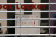 A sign advises shoppers that the Foot Locker store at the Yuba Sutter Mall will not open for a few more days, in Yuba City, Calif., Wednesday, May 6, 2020. Several dozen shoppers streamed into the first California mall to reopen Wednesday, despite Gov. Gavin Newsom's orders restraining businesses because of the coronavirus pandemic. (AP Photo/Rich Pedroncelli)