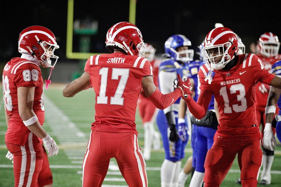 Receiver Jonah Smith celebrates a touchdown with Mater Dei teammates Jack Ressler and Kayden Dixon-Wyatt.