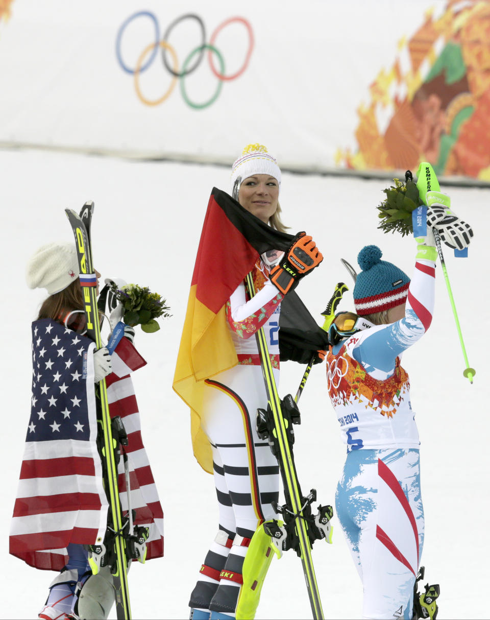 Women's supercombined medalists, from left United States' Julia Mancuso, bronze, Germany's Maria Hoefl-Riesch, gold, and Austria's Nicole Hosp, silver, stand on the podium during a flower ceremony at the Alpine ski venue at the Sochi 2014 Winter Olympics, Monday, Feb. 10, 2014, in Krasnaya Polyana, Russia. (AP Photo/Charles Krupa)